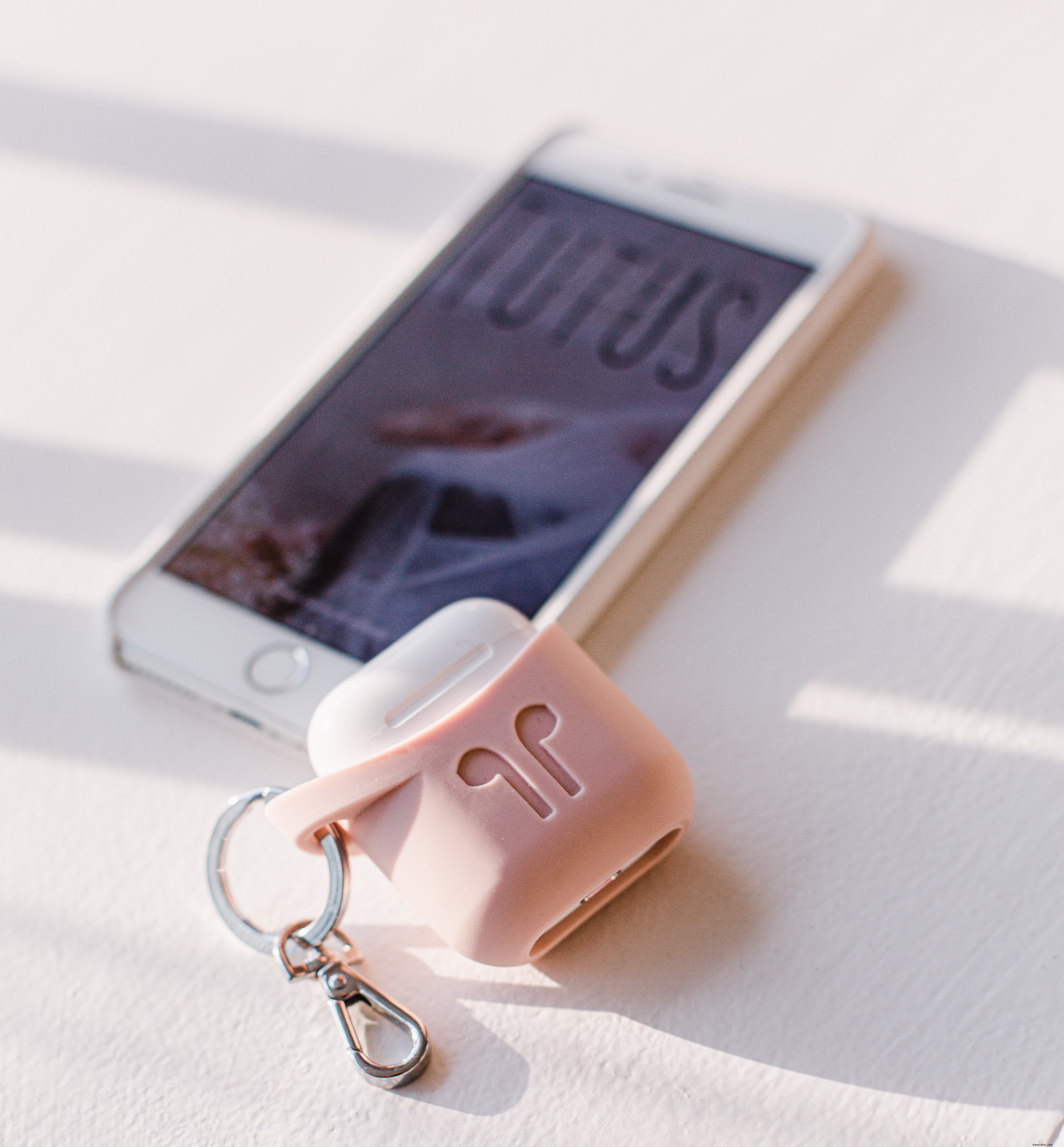 日光が差し込む中の携帯電話とイヤフォン